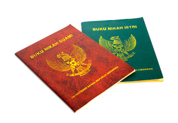 A pair of buku nikah (marriage certificates) for a suami (husband) and istri (wife) isolated on a...