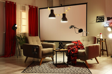 Interior of podcaster's studio with armchairs, projector screen and glowing lamps