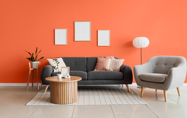 Interior of stylish living room with sofa, armchair and table