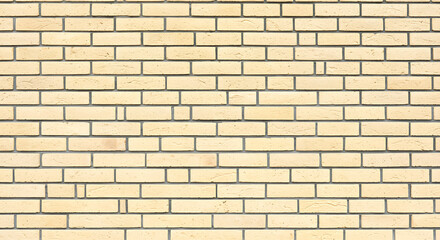 Close up of a light yellow brick wall with dark grey mortar creating a textured and uniform background pattern