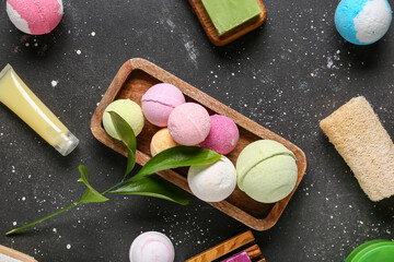 Bath bombs with plant branch on dark background