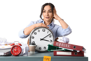 Stressed businesswoman with clock at table on white background. Time management concept