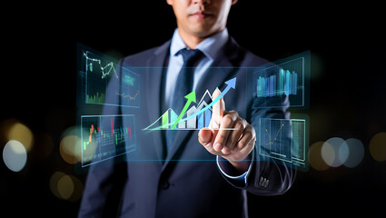 Businessman interacting with holographic financial charts suit display