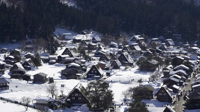 The historic gassho-zukuri village of Shirakawa-go, a famous UNESCO World Heritage site, covered in deep snow during a sunny winter day. Gifu, Japan.