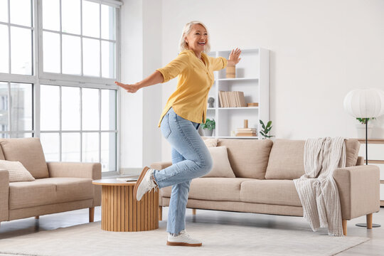 Mature woman dancing at home
