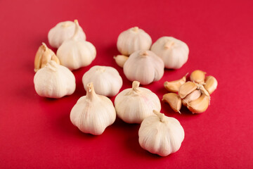 Fresh garlics on red background