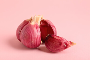 Fresh garlic on pink background