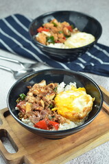 Ricebowl with beef teriyaki and egg served in bowl on the table