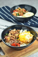 Ricebowl with beef teriyaki and egg served in bowl on the table