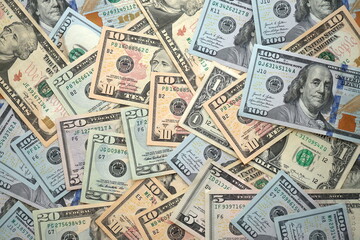 Big amount of different dollar bills close up. Hundred fifty twenty ten and five dollar banknotes