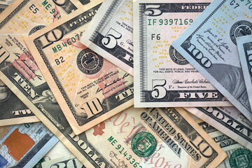 Big amount of different dollar bills close up. Hundred fifty twenty ten and five dollar banknotes