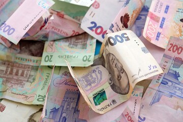 Big amount of different Ukrainian hryvnia money bills. Pile of crumpled ukrainian banknotes
