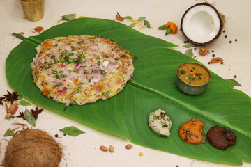 Uthappam or uttapam a type of dosa from South India which is thicker, with tomato, onion and chilli toppings