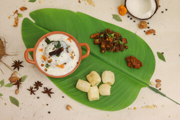 Homemade Curd Rice with pomegranate, cilantro, ginger on a black background. Top view. Traditional Indian South cuisine
