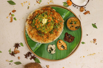 Uthappam or uttapam a type of dosa from South India which is thicker, with tomato, onion and chilli toppings