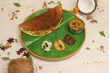 Maysore masala dosa with sambhar and coconut chutney on banana leaf