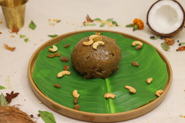 Moong dal halwa indian dessert with dry fruits on banana leaf