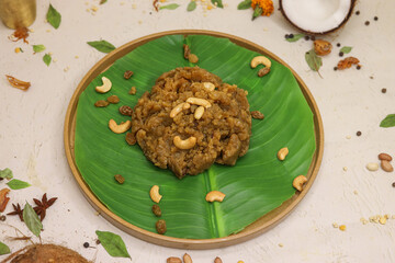Moong dal halwa indian dessert with dry fruits on banana leaf
