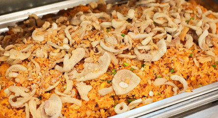 Pork fried rice sprinkled with fragrant fried garlic Put food on tray Buffet food in a luxury hotel.