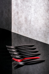 Still life with red and black forks