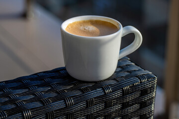 White cup of coffee during the morning, morning ritual - savoring freshly brewed coffee.