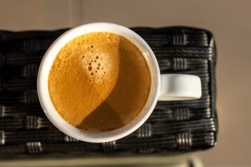 View on the cup of coffee during the morning, morning ritual - savoring freshly brewed coffee.