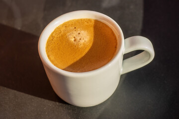 View on the cup of coffee during the morning, morning ritual - savoring freshly brewed coffee.