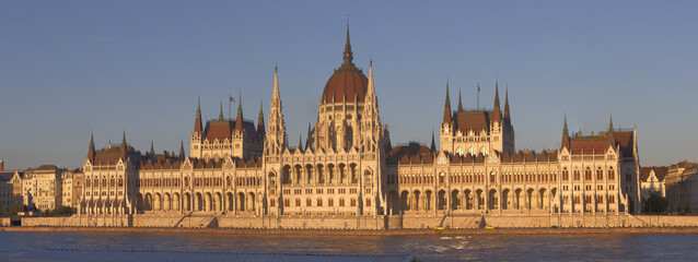 Panoramic view of the Hungarian Parliament during a mild sunset.