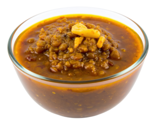 A savory bowl of thick Indian lentil curry or dal garnished with fried garlic.