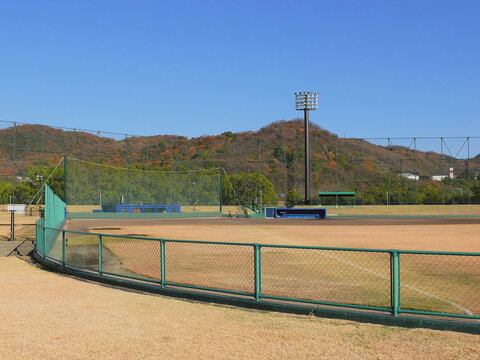 A panoramic view of the baseball stadium, taken from the cheering section, called Alps Stand in Japan, looking toward the thrid base dugout.
