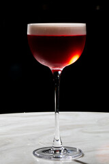 Effervescent crimson elixir in a sultry stemmed glass, autumnal equinox cocktail, transcendental mixology, midsummer night indulgence