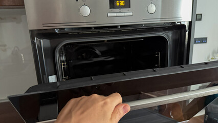 Hand poised before an open oven door, Nordic male, evokes culinary alchemy, Yule-baking warmth, and...