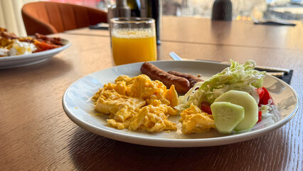 A sunny breakfast symphony, scrambled eggs and vibrant greens, celebrates World Food Day or Sunday brunch rituals, timeless savor