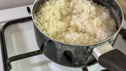 Steaming pot of rice bubbles over, evoking Lunar New Year traditions and nourishing comfort on a...