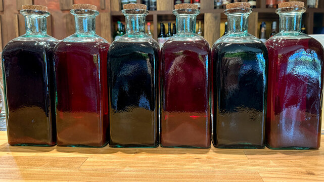 Antique apothecary bottles brim with rich mulberry elixir, perfect for Lammas meditations or whimsical potion-making workshops