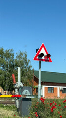 Railroad crossing nestled amid crimson poppies, signaling the quaint dance of heritage travel,...