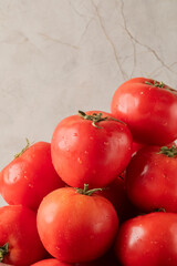 Ripe tomatoes glisten against a marbled backdrop, invoking La Tomatina's juicy fiesta spirit and a...