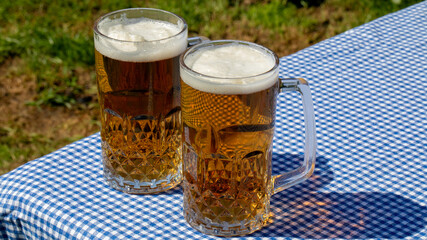 Foamy amber nectar in crystal mugs, Oktoberfest delight  toasting summer's end, Bavarian heritage, convivial gathering vibes © fotoworld