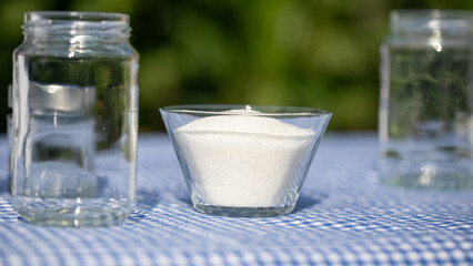 Crystal sugar sparkles in sunshine, picnic serenity on checkered cloth, evoking summer solstice sweetness and rustic charm