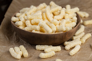 a large number of corn sticks for eating or making breakfast with milk, corn sticks in a wooden bowl, close up