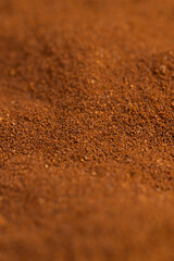an abstract uneven background of ground coffee beans for making a high-quality and aromatic coffee drink, close up