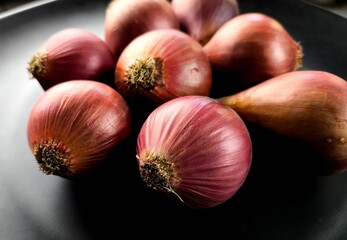 Pile of red onion in plate, indoor Chiangmai Thailand.