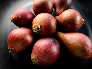 Pile of red onion in plate, indoor Chiangmai Thailand.