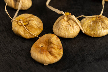 dried figs used in cooking, figs naturally dehydrated in the sun on a black board
