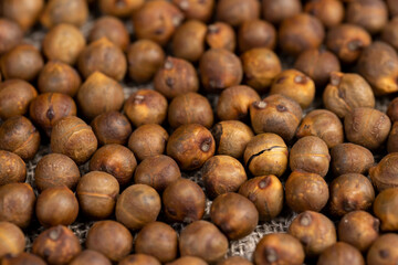 fried but not boiled chickpeas are on the table with a linen tablecloth, closeup