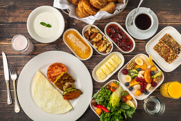 Vegetarian Turkish breakfast with omelet, yogurt and fresh vegetables