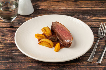 Gourmet roasted duck breast served with root vegetables and sauce