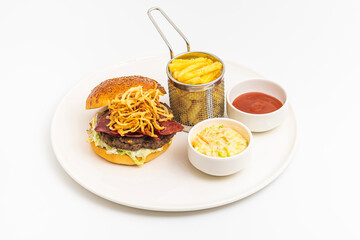 Homemade gourmet burger with crispy fried onions, bacon and French fries