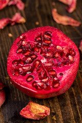 sliced red ripe pomegranate on a black table
