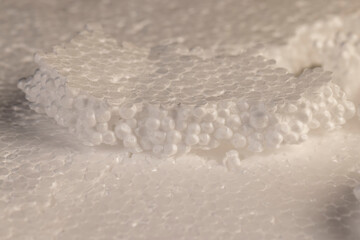 white foam for building insulation , foam made from a large number of pieces joined together, close up